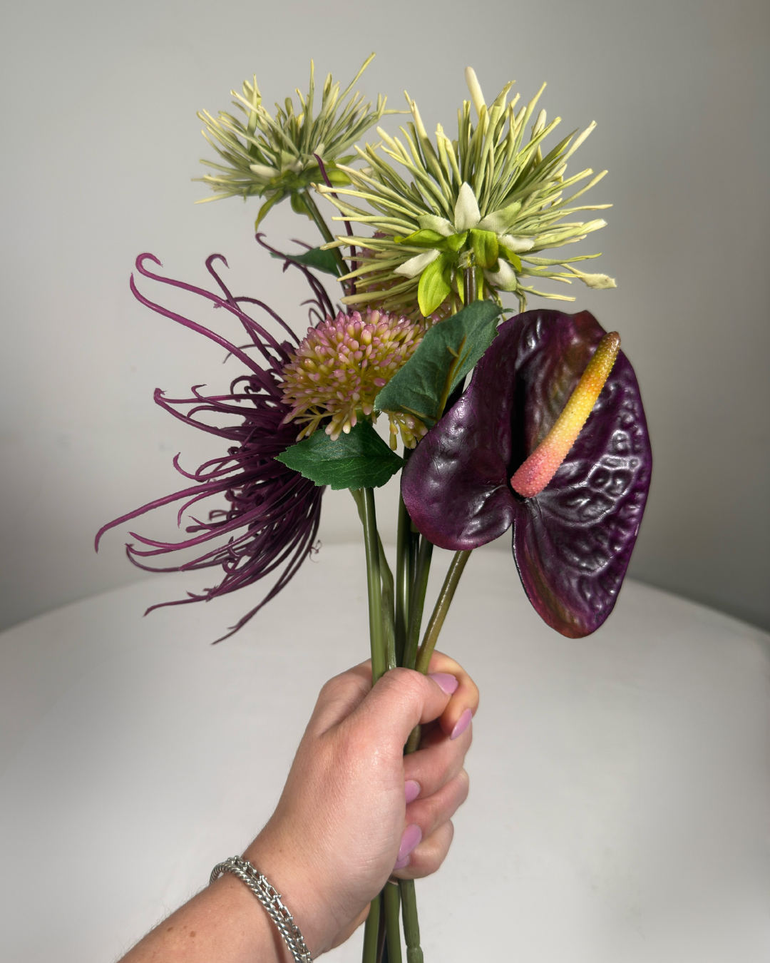 The Delancey Mini silk arrangement styled on a nightstand.