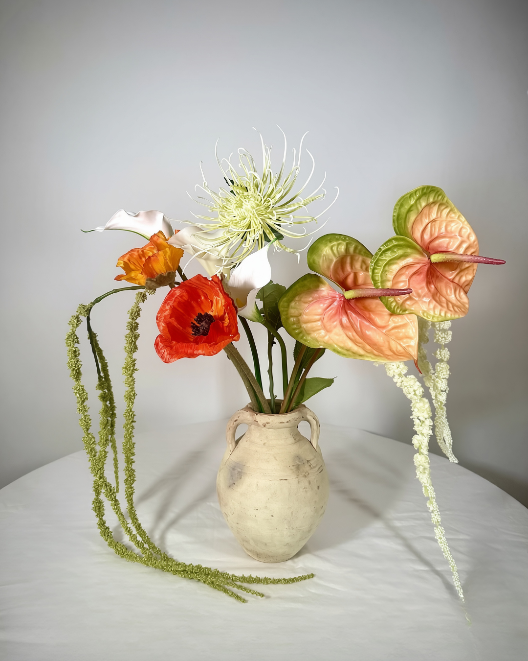 The Henry St Large — statement warm copper silk flower arrangement with real-touch orange anthurium, calla lily, and poppy in a ceramic vessel. Made to order in NYC.
