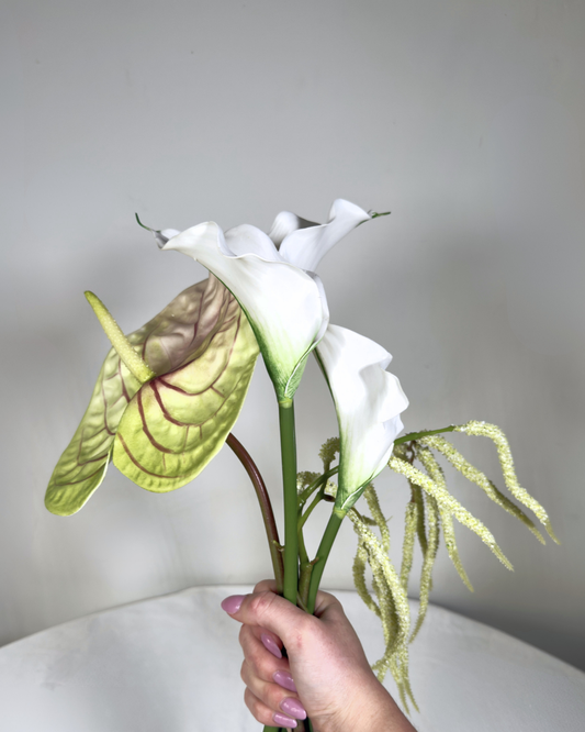 Hand holding The Sara J Mini silk bouquet showing white calla lily and anthurium stems.