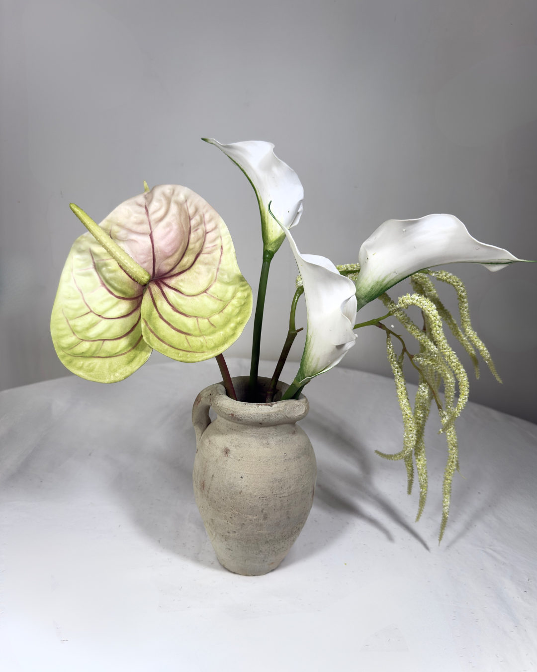 The Sara J Mini — compact white silk flower arrangement with real-touch anthurium, calla lily, and trailing amaranthus in a ceramic vessel. NYC made-to-order.