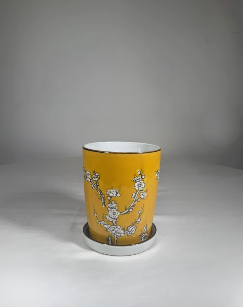 Small 7-inch hand-painted ceramic bud vase with a bright printed pattern. Hand-picked in NYC.