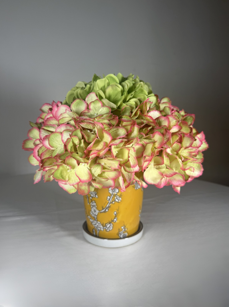 Hand-painted ceramic bud vase shown from a second angle, small bright printed pattern.