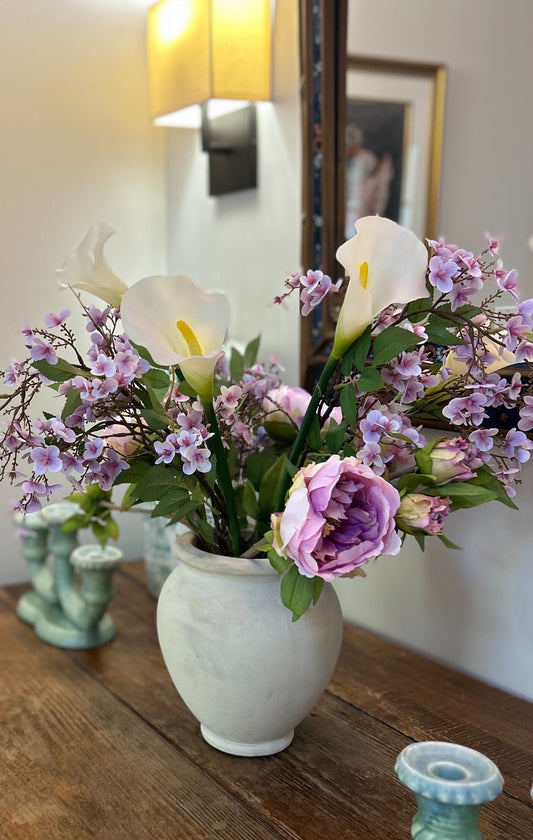 The Mimi — silk white calla lilies, pink peonies, and cherry blossom branches in a cream stone vase. Made to order in NYC.